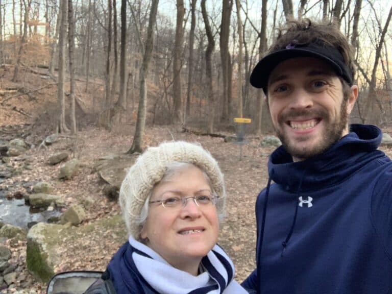 Susan Goldsmith out on a wooded disc golf course